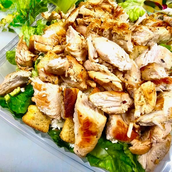 Milano's Pizza chicken Caesar salad with grilled chicken, croutons, and fresh lettuce.